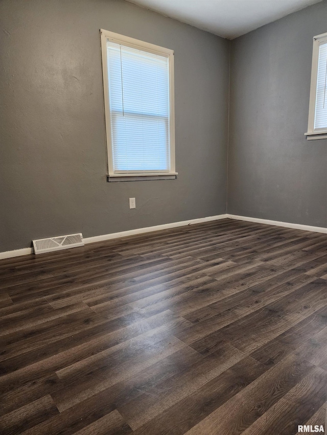 spare room featuring dark wood-type flooring