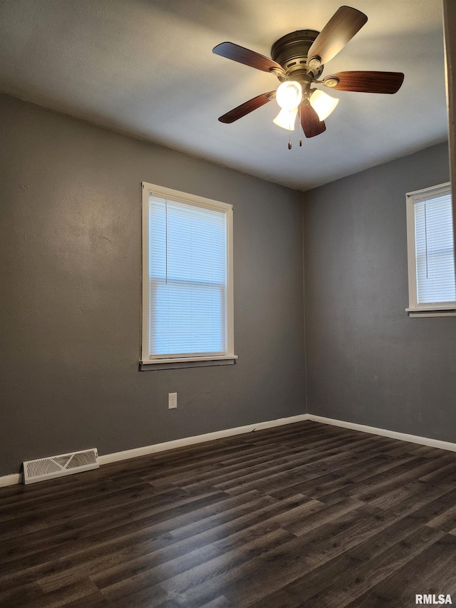 unfurnished room featuring ceiling fan and dark hardwood / wood-style flooring