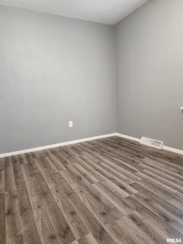 unfurnished room featuring dark wood-type flooring