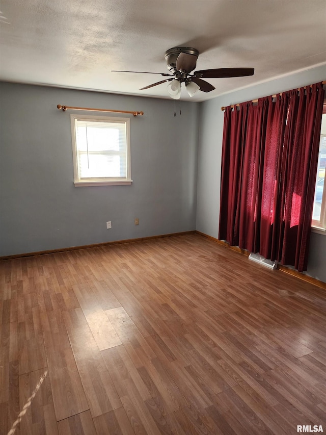 spare room with hardwood / wood-style flooring and ceiling fan