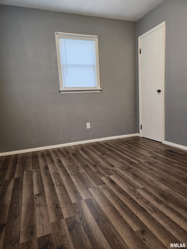 unfurnished room featuring dark hardwood / wood-style flooring