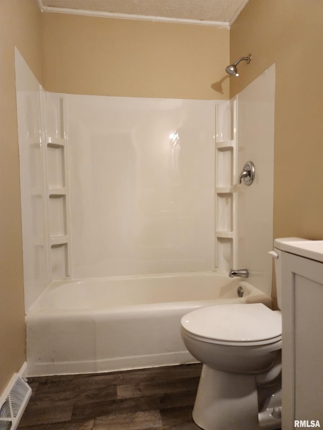 full bathroom featuring toilet, washtub / shower combination, ornamental molding, and hardwood / wood-style flooring