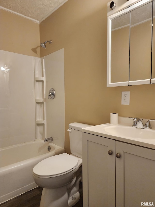 full bathroom with washtub / shower combination, wood-type flooring, a textured ceiling, toilet, and vanity