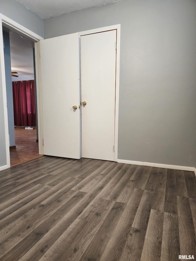 empty room with dark hardwood / wood-style flooring