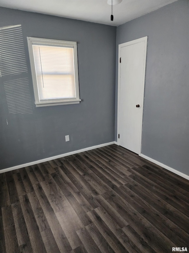 unfurnished room featuring dark hardwood / wood-style flooring