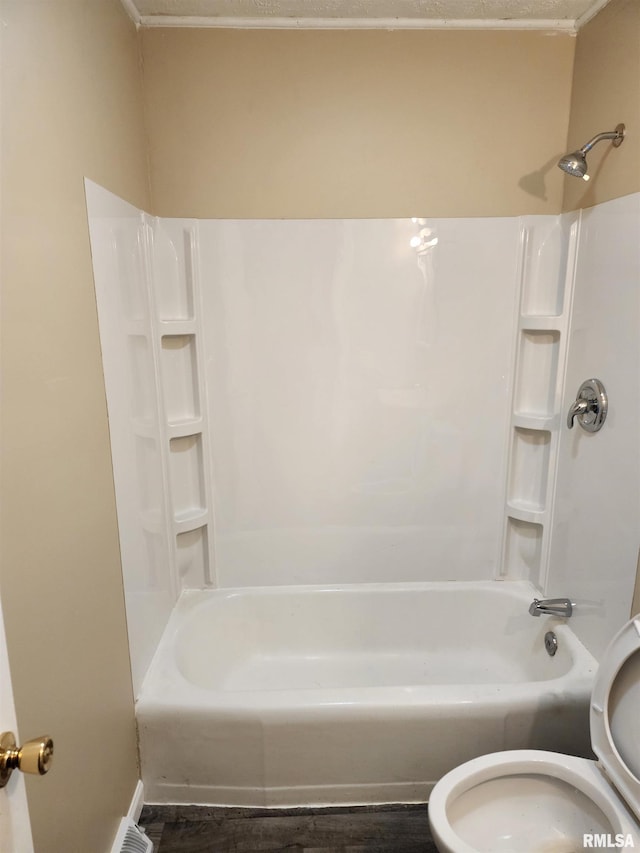 bathroom with toilet and washtub / shower combination