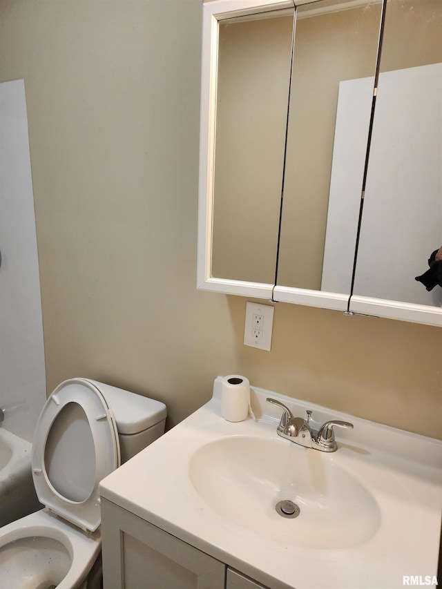 bathroom featuring vanity and toilet