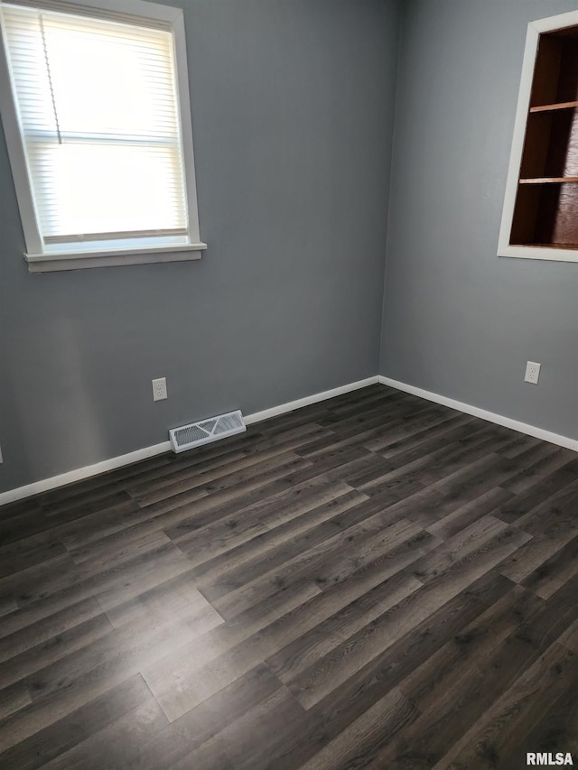 unfurnished room featuring dark hardwood / wood-style flooring