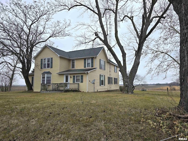 exterior space with a wooden deck and a front yard