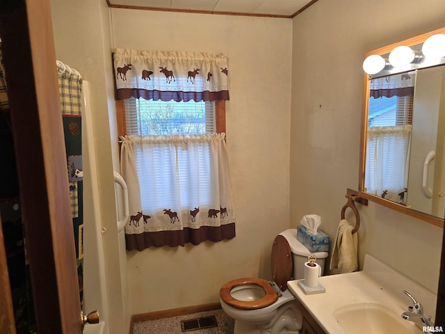 bathroom featuring vanity, ornamental molding, and toilet