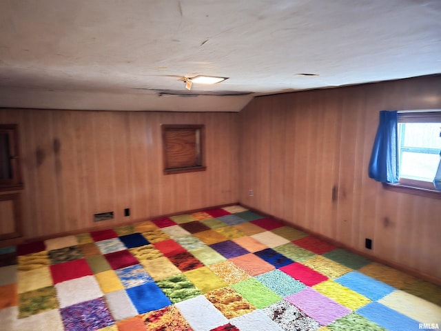 empty room featuring wooden walls