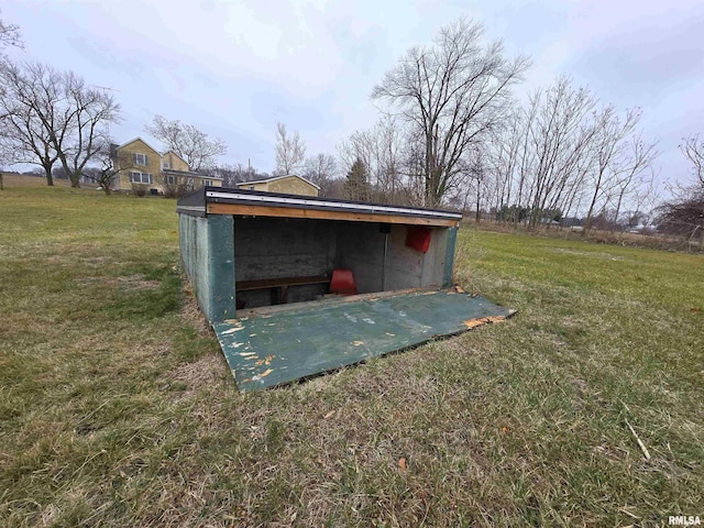 view of outbuilding with a yard