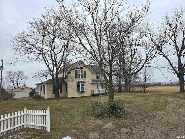 view of front of house featuring a front yard, a garage, and an outdoor structure