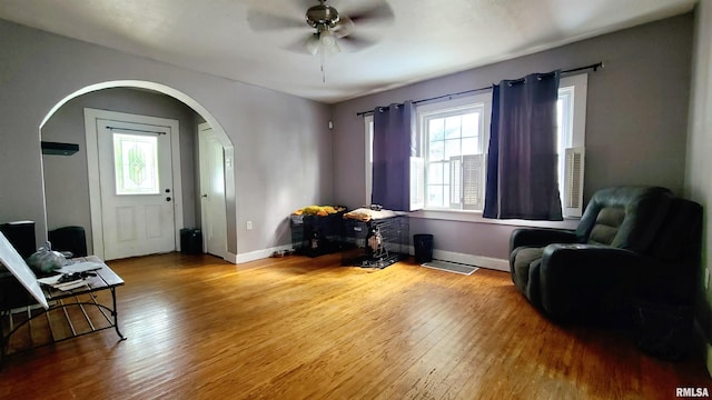 living area featuring ceiling fan and hardwood / wood-style flooring