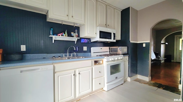 kitchen featuring white appliances, light hardwood / wood-style flooring, and sink