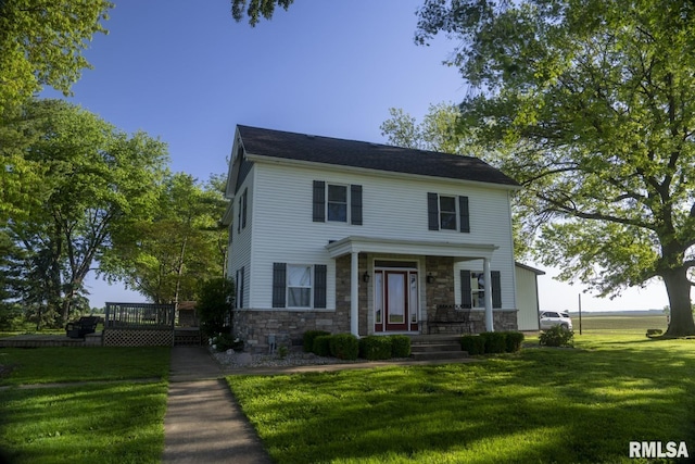 colonial-style house featuring a front lawn