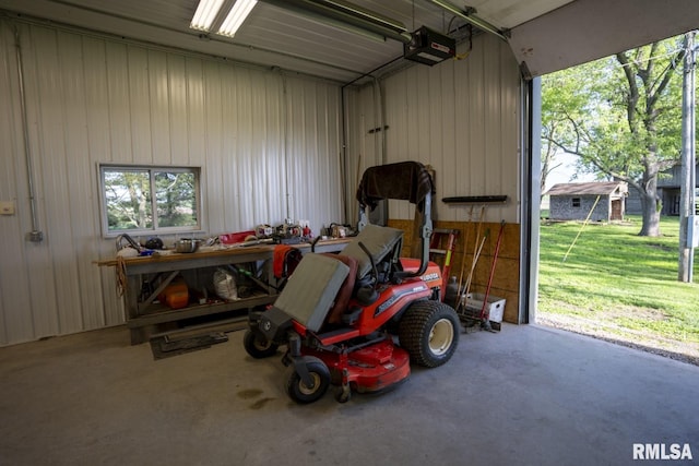 garage with a lawn and a garage door opener