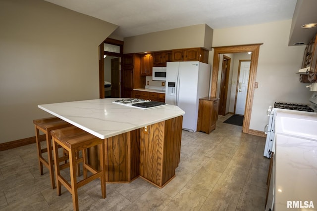 kitchen with a center island and white appliances