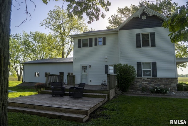 back of house featuring a yard and a deck