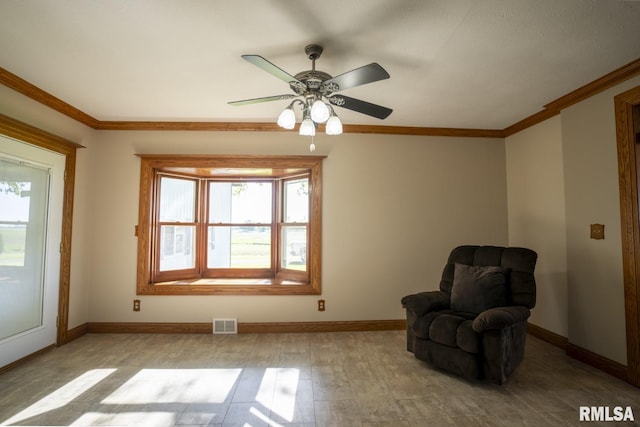 unfurnished room with ceiling fan and crown molding