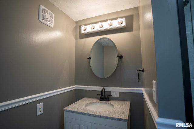 bathroom featuring vanity and a textured ceiling