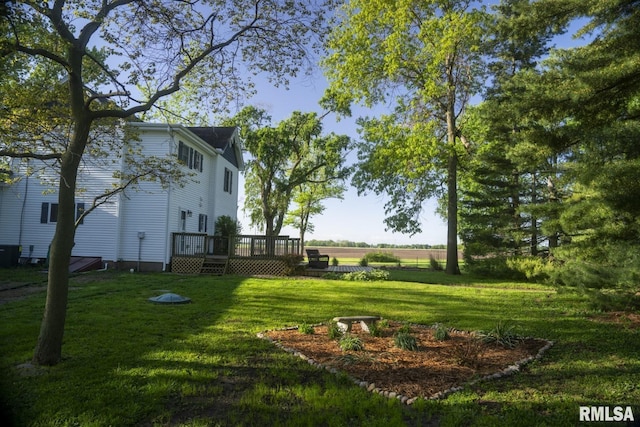 view of yard with a deck and central AC