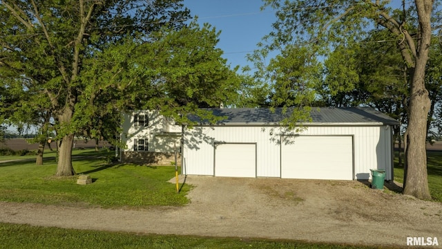 garage featuring a lawn