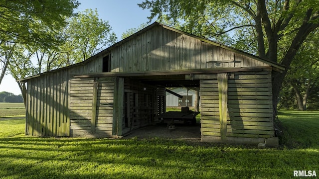 view of outbuilding featuring a yard