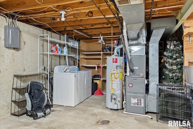 basement featuring heating unit, independent washer and dryer, electric panel, and water heater