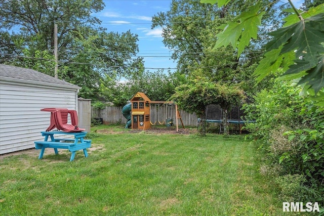 view of yard featuring a trampoline and a playground