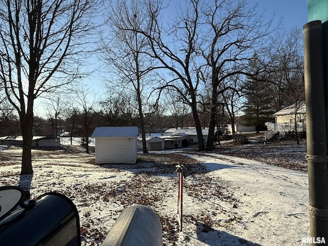 exterior space with a storage shed and an outbuilding