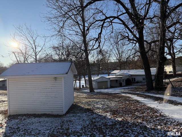 exterior space featuring an outbuilding and a garage