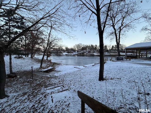 snowy yard featuring a water view