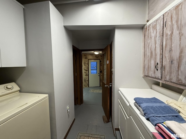 clothes washing area featuring washer / dryer and cabinet space