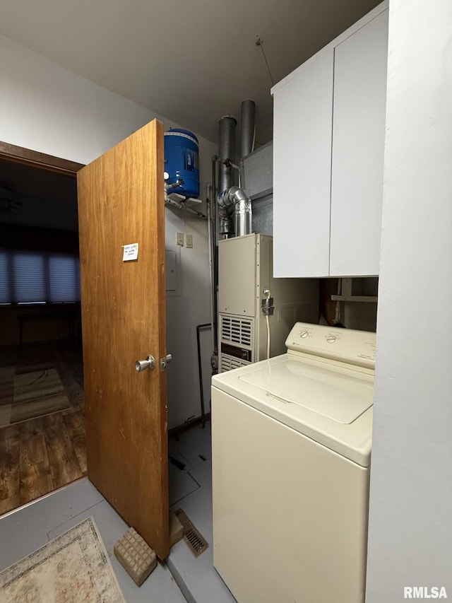 clothes washing area with washer / clothes dryer and cabinet space