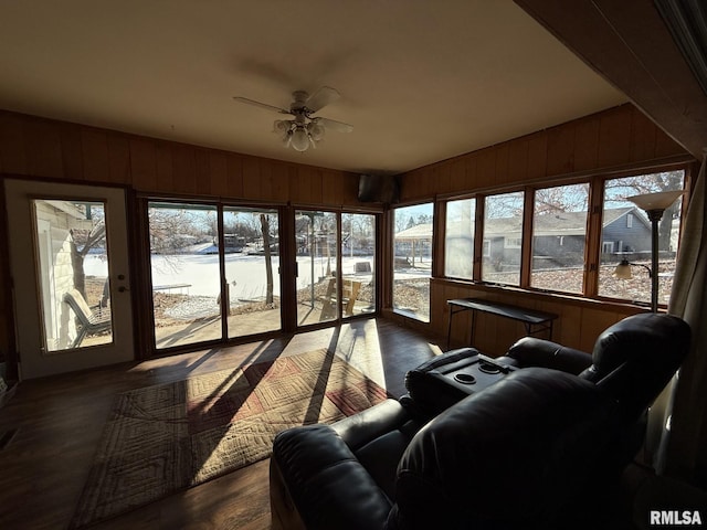 sunroom featuring lofted ceiling, a water view, and a ceiling fan