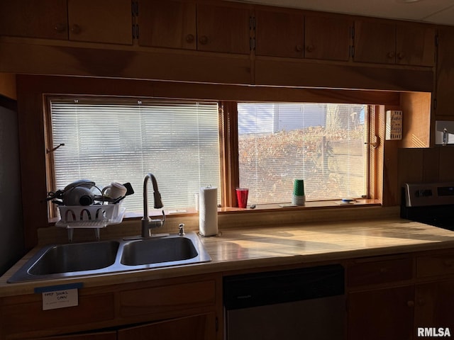 kitchen with light countertops, appliances with stainless steel finishes, and a sink