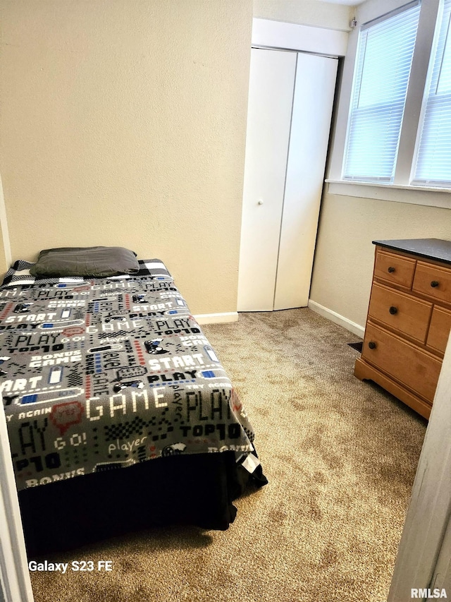 carpeted bedroom featuring a closet