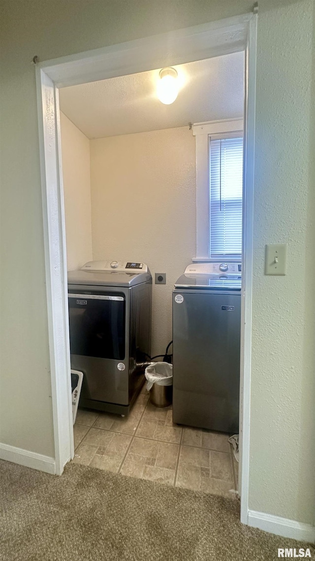 washroom featuring light colored carpet and washing machine and clothes dryer