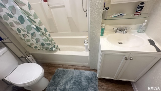 full bathroom featuring vanity, hardwood / wood-style flooring, shower / bath combination with curtain, and toilet