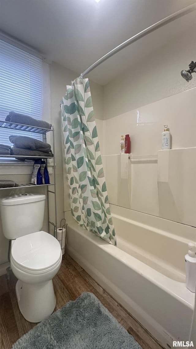 bathroom featuring toilet, hardwood / wood-style floors, and shower / bath combo