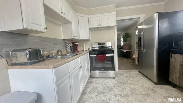 kitchen with white cabinetry, appliances with stainless steel finishes, sink, and decorative backsplash