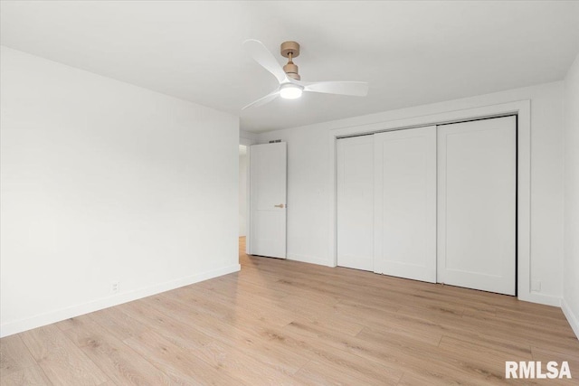 unfurnished bedroom featuring ceiling fan, a closet, and light hardwood / wood-style flooring