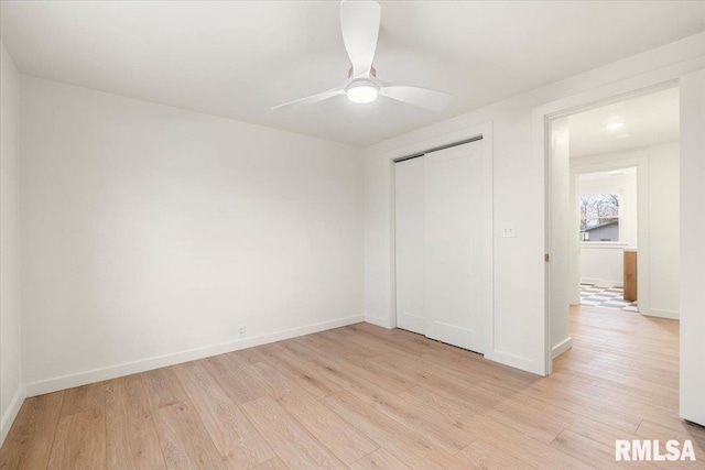 unfurnished bedroom with ceiling fan, light hardwood / wood-style flooring, and a closet