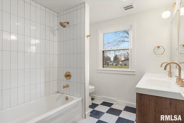 full bathroom featuring vanity, toilet, and tiled shower / bath