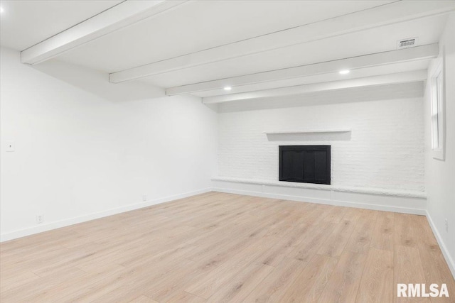 basement with light hardwood / wood-style floors