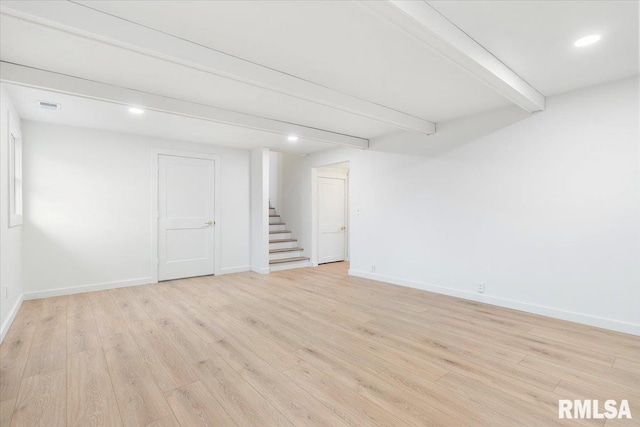 basement with light hardwood / wood-style floors