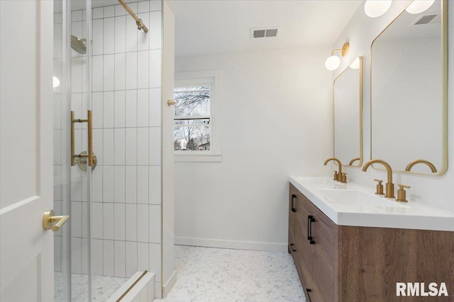 bathroom featuring a tile shower and vanity