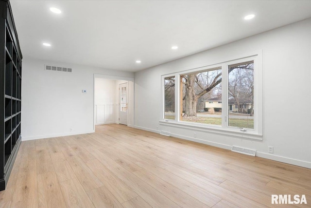 unfurnished living room with light hardwood / wood-style flooring