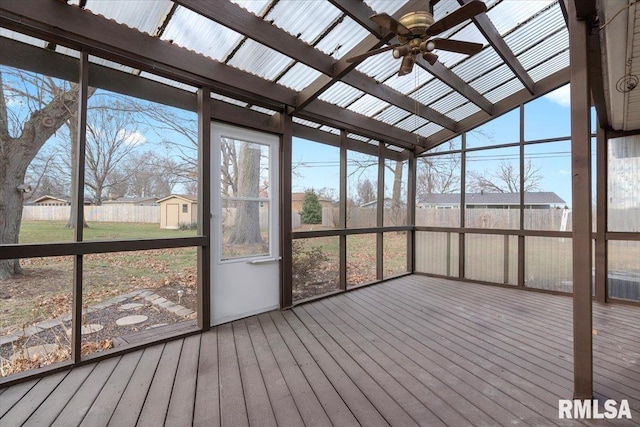 unfurnished sunroom featuring ceiling fan